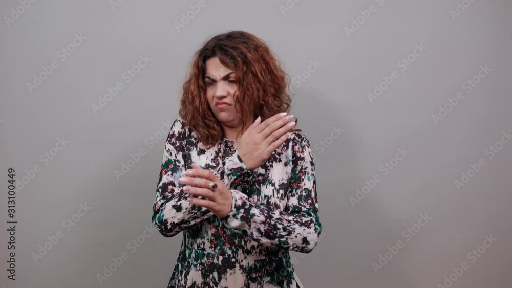 Serious young lady over isolated gray background in fashion shirt keeping hands crossed, doing stop, NO gesture, having nice ring. People emotions. Lifestyle concept Serious young lady over isolated gray background in fashion shirt keeping hands crossed, doing stop, NO gesture, having nice ring. People emotions. Lifestyle concept
