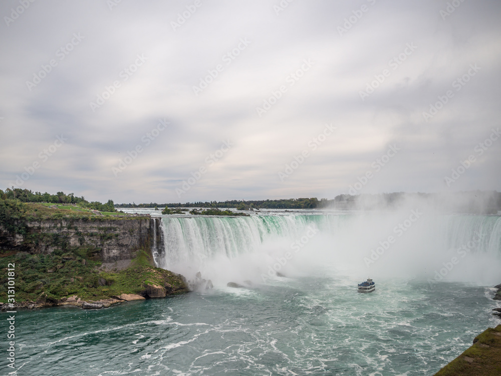 Niagara Falls, New York state, United States of America and Canada - edge of Niagara falls, town from American and Canadian city side, falling water and mist Niagara Falls, New York state, United States of America and Canada - edge of Niagara falls, town from American and Canadian city side, falling water and mist
