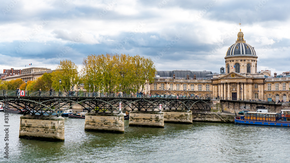 View from Pont des arts and Seine river during Autumn season in the afternoon cloudy day . One of the most important bridge in  the heart of Paris , France