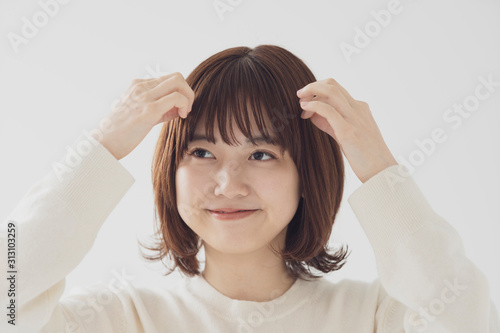 前髪を整える女性 photo