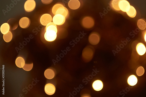beautiful yellow bokeh lights background on dark