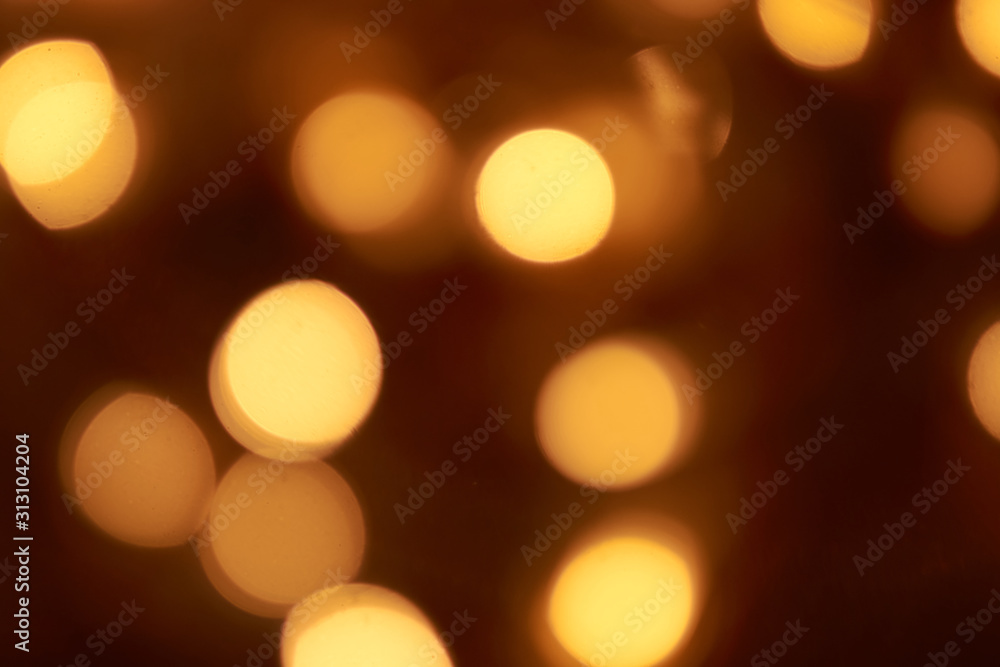Fototapeta premium beautiful yellow bokeh lights background on dark