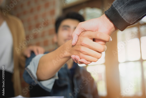Two confident business man shaking hands during a meeting in the office, success, dealing, greeting and partner concept.