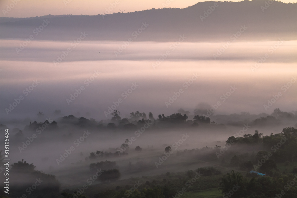 sunrise in mountains with white fog