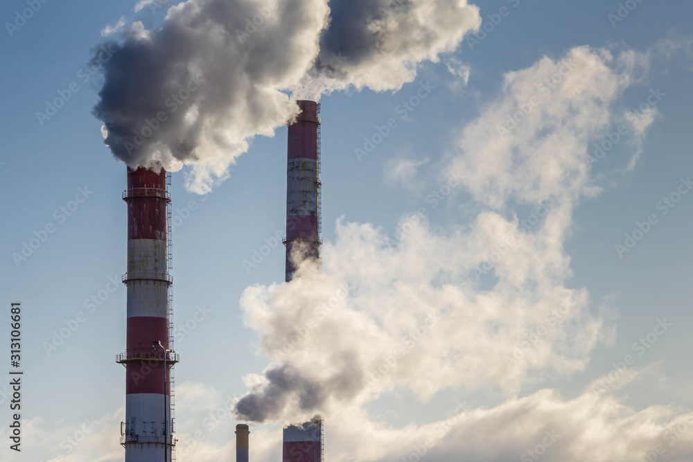 Smoke coming from three factory chimneys. Global warming. Air pollution. Smoke coming from three factory chimneys. Global warming. Air pollution.