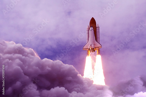 The launch of the space shuttle in an unusual, purple color. Elements of this image were furnished by NASA
