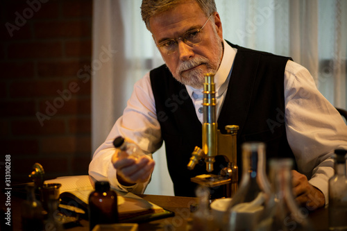 1885 scientist thinking while holding a drug