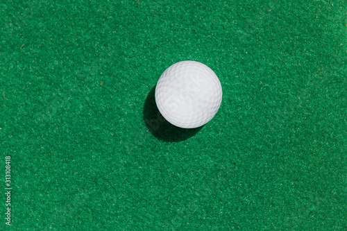 golf ball on green background top view