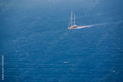Sea view from Oia village in Santorini with ship on it at sunny weather © STUDIO MELANGE