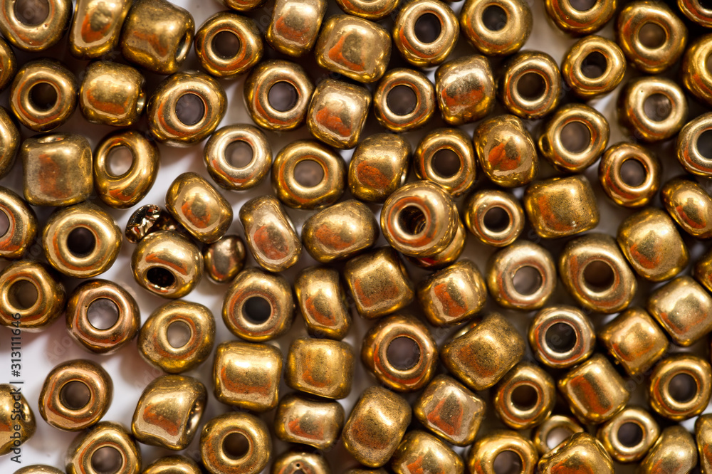 Round golden beads designed for making jewelry shot large on a white background Round golden beads designed for making jewelry shot large on a white background
