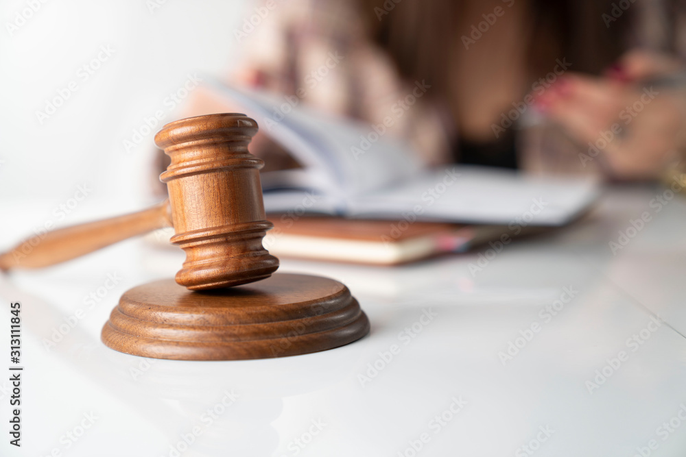 Female layer – businesswoman working in the office. Gavel on the white table. Female layer – businesswoman working in the office. Gavel on the white table.