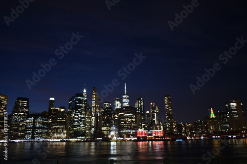 New york skyline from brooklyn at night with water reflection © Majed