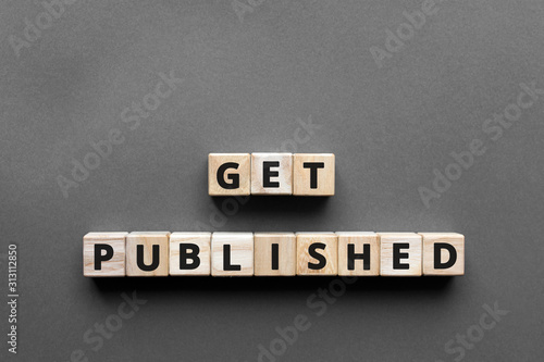 Get published - words from wooden blocks with letters, get published concept, top view gray background