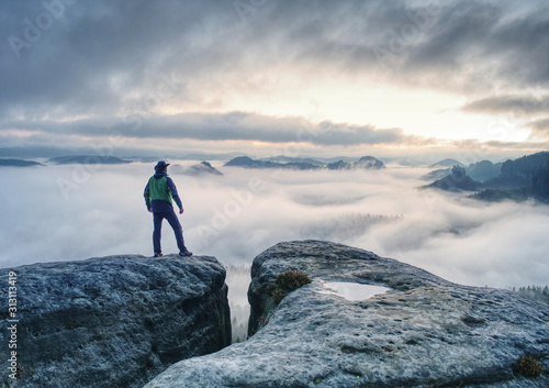 Man finnaly standing on rock and enjoy foggy mountain view