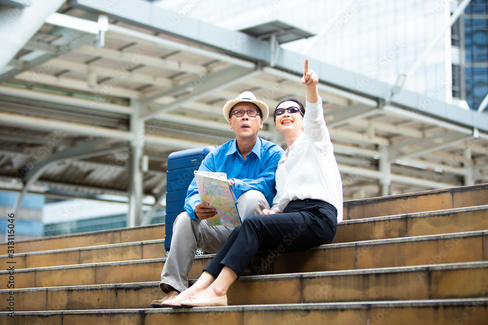Senior couple traveling with luggage checking city map and sightseeing Travel and tourism concept. Senior couple traveling with luggage checking city map and sightseeing Travel and tourism concept.