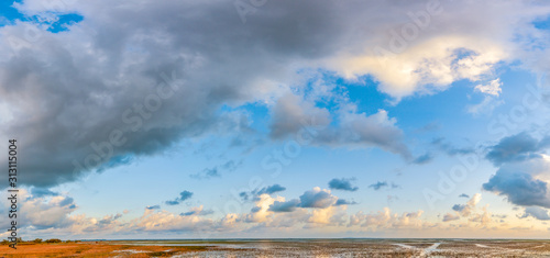 Panorama of a beautiful blue sky filled with gray clouds over over the big lake at Thale Noi Waterfowl Reserve nonihunting area   the famous for its attractions in Thailand.