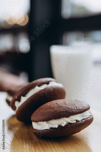 Close up Traditional chocolate and Pumpkin Whoopie pies made with vanilla cream cheese. Background for bakeries, cafes, restaurants photo