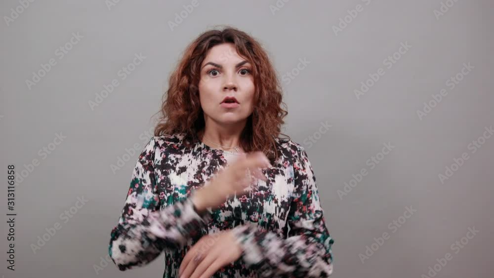 Shocked charming caucasian young woman keeping hands on head with opened mouth, looking confused over isolated gray background in fashion shirt. Lifestyle concept Shocked charming caucasian young woman keeping hands on head with opened mouth, looking confused over isolated gray background in fashion shirt. Lifestyle concept