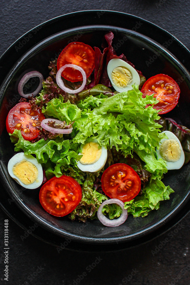 healthy salad vegetables, quail eggs (tomato, lettuce and other ingredients) menu concept. food background. top view. copy space