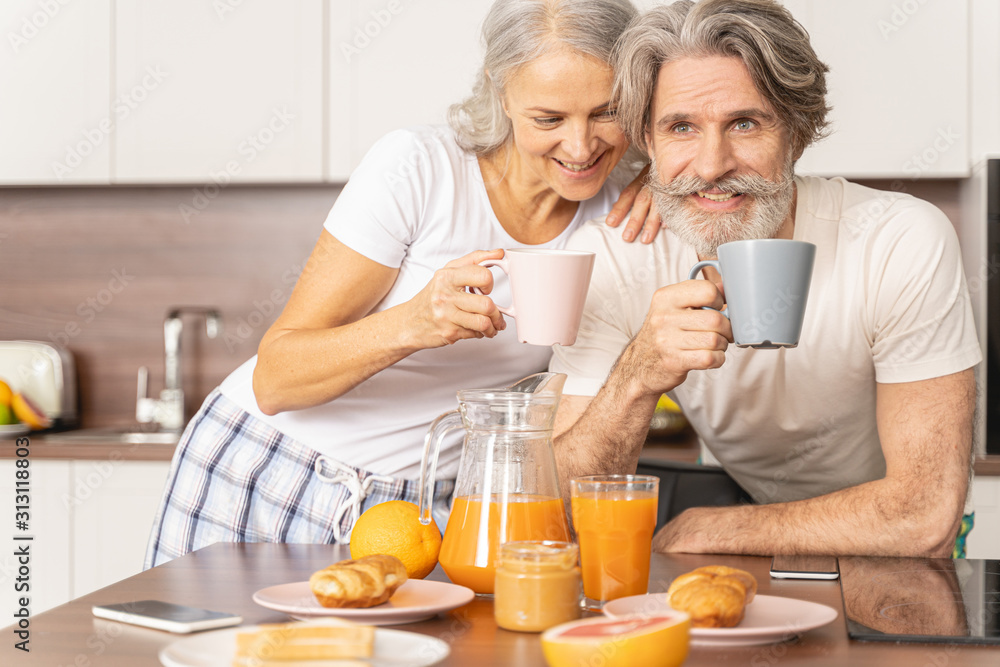 Smiling man and his wife drinking tea Smiling man and his wife drinking tea