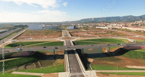 Aerial view over commercial area in the suburbs of Barcelona, Spain, showing highway roads, a roundabout and a construction site in development