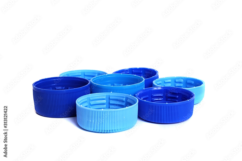 blue plastic bottle caps isolated on white background. Solutions for recycling plastic waste. blue plastic bottle caps isolated on white background. Solutions for recycling plastic waste.