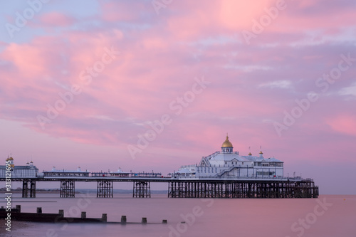 Eastbourne Pier at dusk with pink skies and calm sea