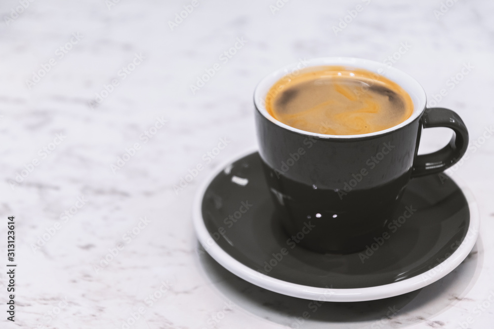Coffee Espresso. Black Ceramic Cup Of Coffee on white stone table background. Coffee Espresso. Black Ceramic Cup Of Coffee on white stone table background.