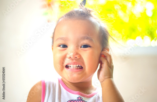 The happy Asian girl's face with a smile.