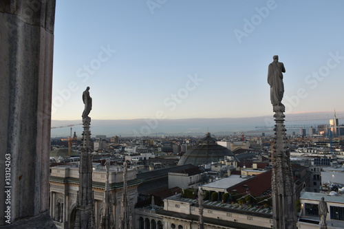 Milan rooftop with city in background and sunset
