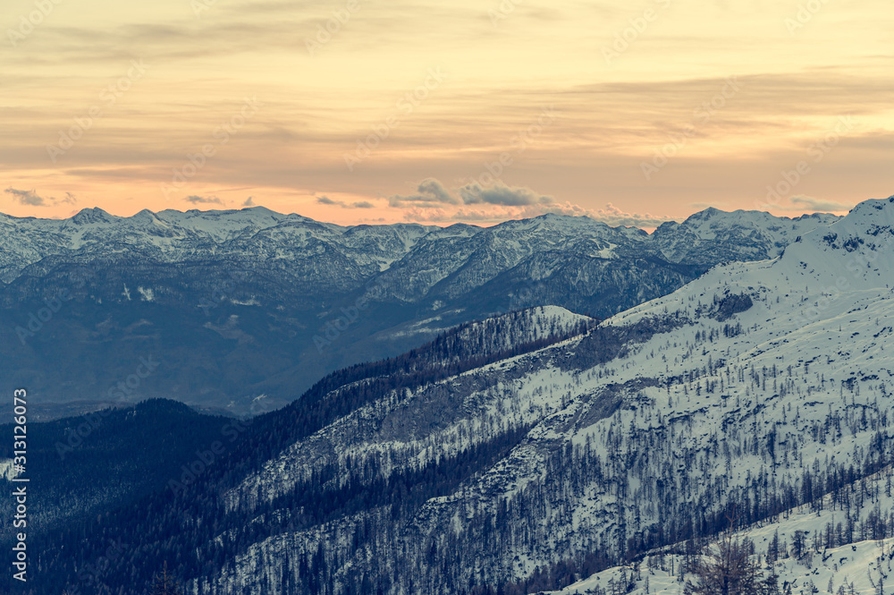 Spectacular winter mountain panoramic view of mountains at sunset.