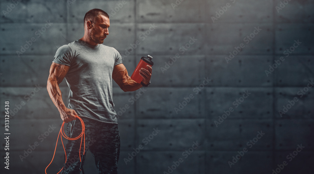 Nutritional Supplement. Muscular Men Drinks Protein, Energy Drink After