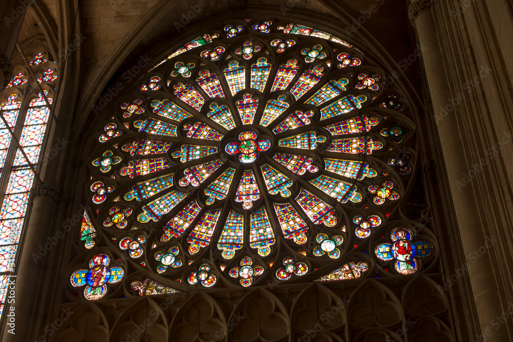 Carcassonne, France, 25 June 2019: Decorative stained glass window rose in the historic Saint Nazaire basilica in Carcassonne