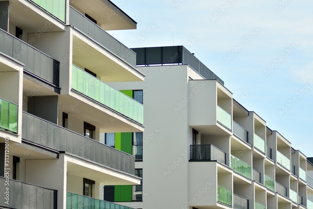 Contemporary residential building exterior in the daylight. Modern apartment buildings on a sunny day with a blue sky. Facade of a modern apartment building Contemporary residential building exterior in the daylight. Modern apartment buildings on a sunny day with a blue sky. Facade of a modern apartment building