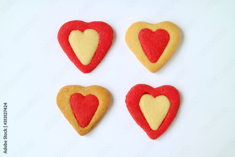Four of vibrant color heart shaped two tone butter cookie on white background