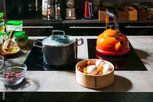 Orange kettle and pot on stove in the kitchen