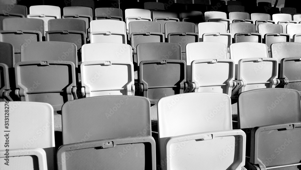 Naklejka premium Many rows of white - grey plastic seats in the stadium