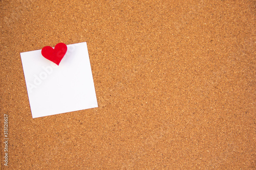 cork board with red heart note