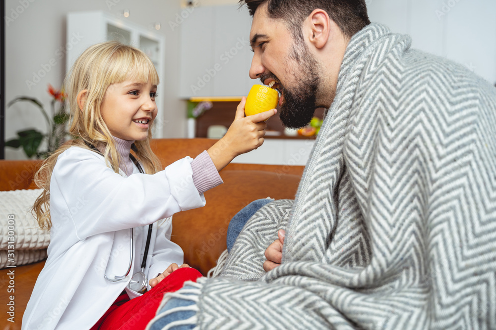 Cute little girl giving father lemon to eat Cute little girl giving father lemon to eat