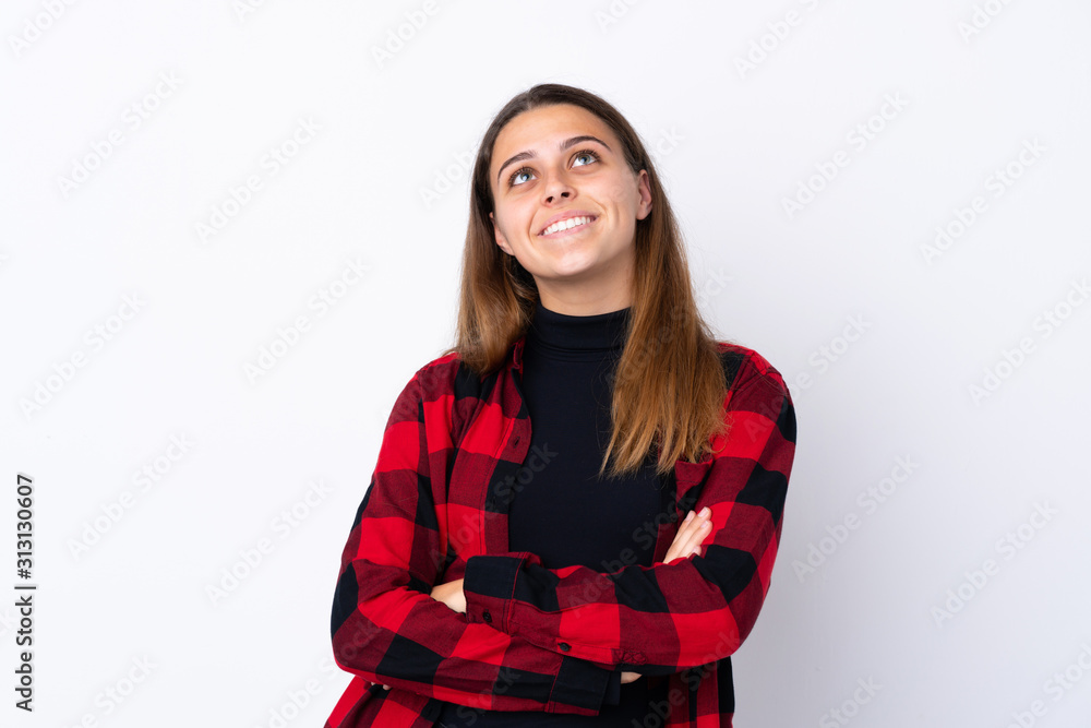 Teenager girl over isolated white background looking up while smiling Teenager girl over isolated white background looking up while smiling