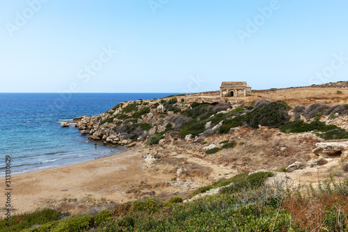 Northern Cyprus travel. The ruins of an ancient building on the island. Summer seashore with transparent blue water. Seascape. Skyline.