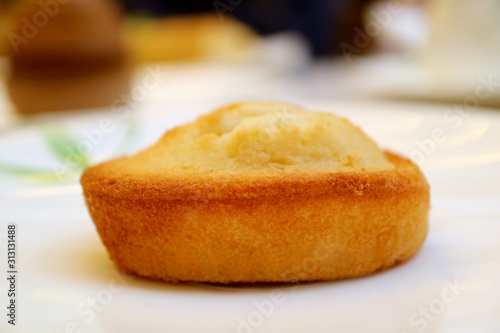 Closeup a Financier, French Almond Petit-Four Cake Served on White Plate
