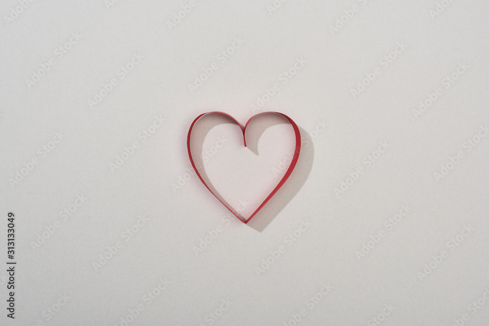 Top view of red paper heart on grey background with copy space