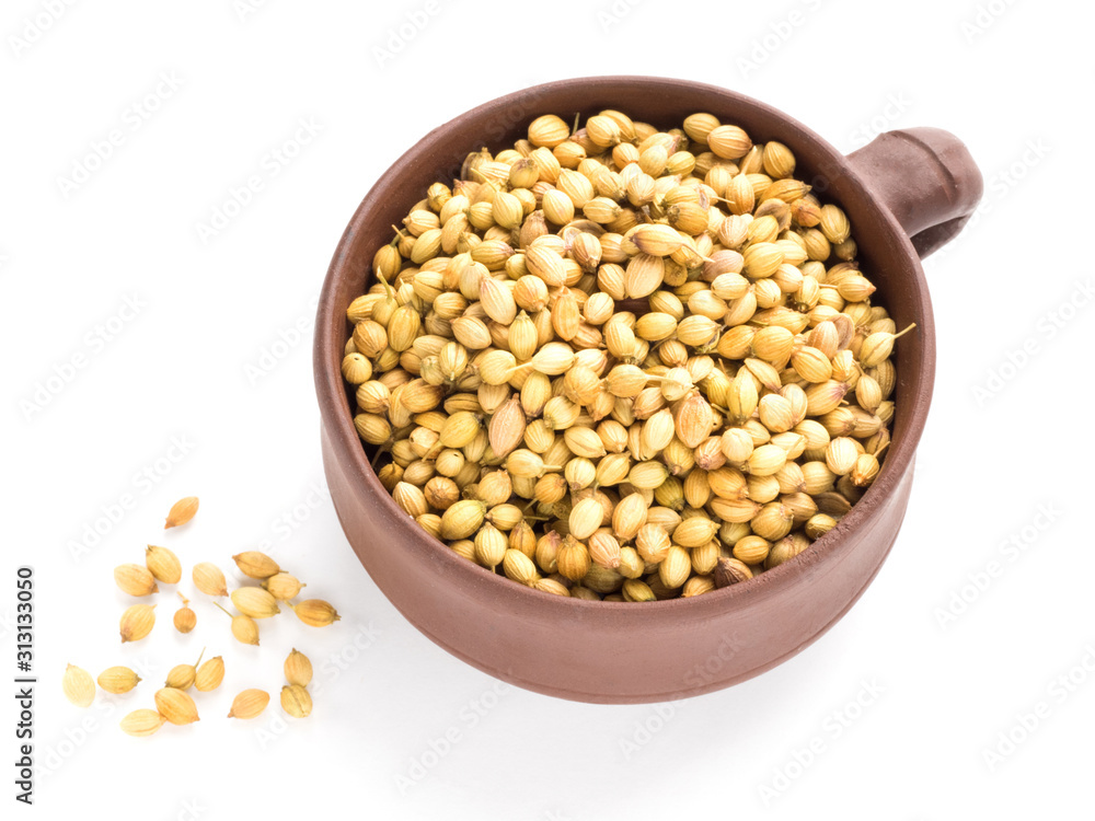 Spice coriander (Coriandrum sativum) seeds in clay cup isolated on white background. Healthy eating concept Spice coriander (Coriandrum sativum) seeds in clay cup isolated on white background. Healthy eating concept