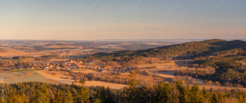 panorama landscape with villages, forests, meadows, fields and hills, blue sky