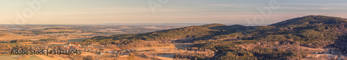 panorama landscape with villages, forests, meadows, fields and hills, blue sky