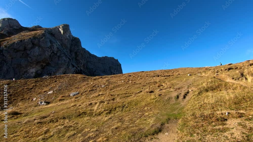 Forward dolly moving Alps mountain edge covered with grass under Mangart peak, Slovenia Forward dolly moving Alps mountain edge covered with grass under Mangart peak, Slovenia