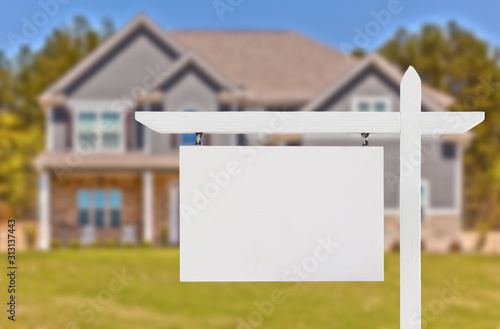 Blank Real Estate Sign in Front of Beautiful New House photo