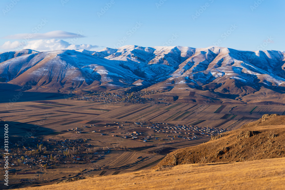Amazing snowy mountain landscape with settlements, Armenia