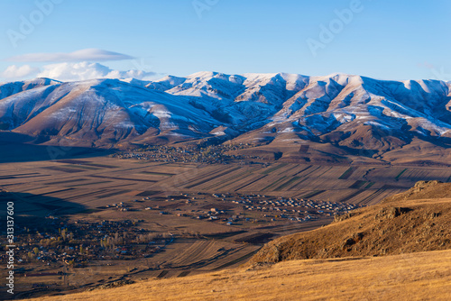 Amazing snowy mountain landscape with settlements, Armenia